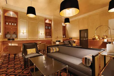 a living room with a couch and a table at Executive Hotel Le Soleil New York in New York