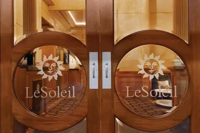 a wooden door with two round mirrors on it at Executive Hotel Le Soleil New York in New York