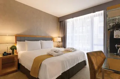 a hotel room with a large bed and a window at Executive Hotel Le Soleil New York in New York