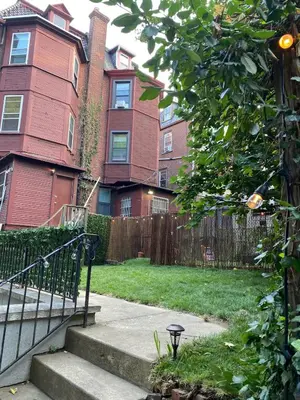 a house with a fence and stairs in a yard at Brand New Modern Flat, Heart of University City in Philadelphia