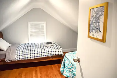 a bedroom with a bed and a window at Spacious Cozy Retreat, Sleeps 10, Near NYC & EWR in Newark