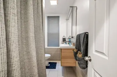 a bathroom with a toilet and a shower curtain at New 1-BD in Prime Philly Location with King Bed in Philadelphia