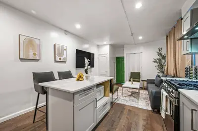 a kitchen with an island in the middle of a room at New 1-BD in Prime Philly Location with King Bed in Philadelphia