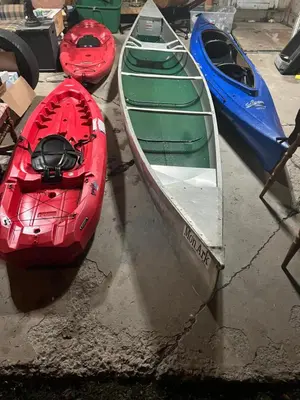 three canoes are sitting on the ground next toermottermott at Hillsaps Ranch on the Lake in Gouldsboro