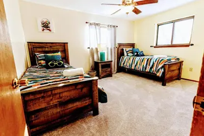 a bedroom with two beds and a window at The CubHouse Poconos getaway in Tobyhanna