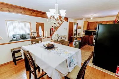 a kitchen and dining room with a table and chairs at The CubHouse Poconos getaway in Tobyhanna