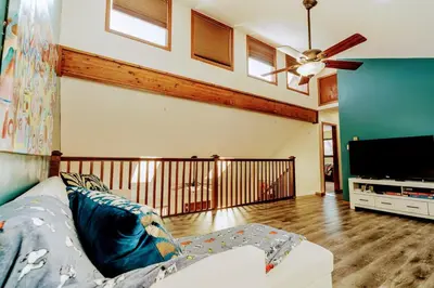 a living room with a couch and a flat screen tv at The CubHouse Poconos getaway in Tobyhanna