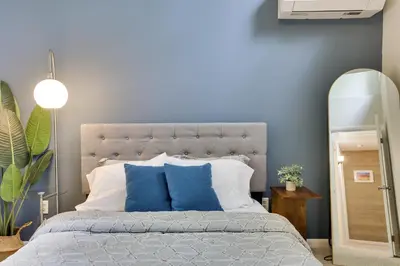 a bedroom with a large bed with blue pillows at Dreamy Lake House - Fireplace, Firepit & Pet Friendly in Pocono Lake