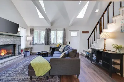 a living room with a couch and a fireplace at Dreamy Lake House - Fireplace, Firepit & Pet Friendly in Pocono Lake