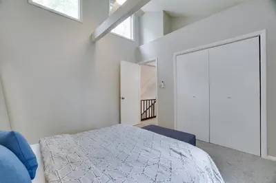 a bedroom with a bed and a door with skylights at Dreamy Lake House - Fireplace, Firepit & Pet Friendly in Pocono Lake