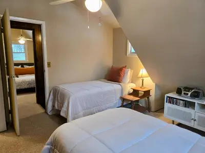 a bedroom with two beds and a door to a room at Charming, Pet-friendly Lake front Retreat WiFi in Ferndale