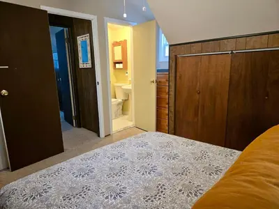 a bedroom with a bed and a bathroom at Charming, Pet-friendly Lake front Retreat WiFi in Ferndale