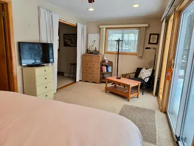 a bedroom with a bed and a tv and a table at Charming, Pet-friendly Lake front Retreat WiFi in Ferndale