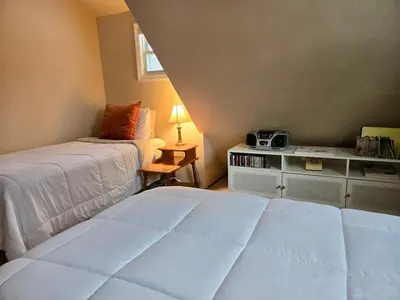 a bedroom with two beds and a table with a radio at Charming, Pet-friendly Lake front Retreat WiFi in Ferndale