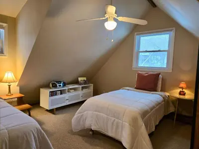 a bedroom with two beds and a ceiling fan at Charming, Pet-friendly Lake front Retreat WiFi in Ferndale