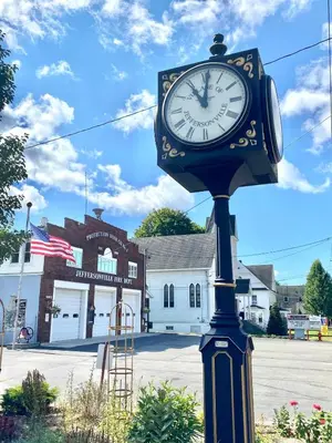 a clock on top of a pole on a street at In the clouds your cozy- lake house in Swan Lake