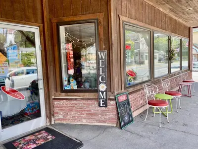 a restaurant with chairs and a sign in the window at In the clouds your cozy- lake house in Swan Lake