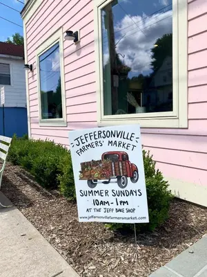 a sign in front of a pink house at In the clouds your cozy- lake house in Swan Lake