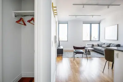 a white living room with a couch and a table at Hells Kitchen 1BR w Doorman nr Central Park NYC-521 in New York