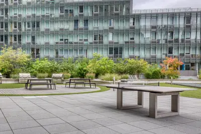 two benches and a table in front of a building at Hells Kitchen 1BR w Doorman nr Central Park NYC-521 in New York