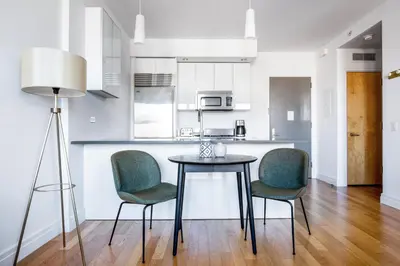 a kitchen and dining room with a table and chairs at Hells Kitchen 1BR w Doorman nr Central Park NYC-521 in New York
