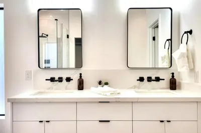 two sinks in a bathroom with two mirrors at Modern Living in PHX Heated Pool Arizona Charm in Philadelphia