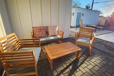 a patio with three chairs and a bench and a table at Modern Living in PHX Heated Pool Arizona Charm in Philadelphia