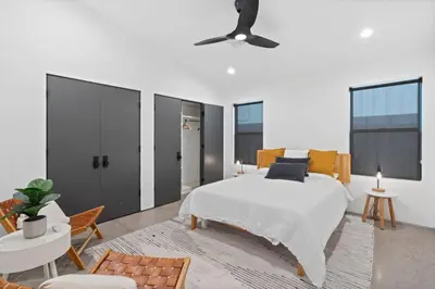 a bedroom with a bed and a ceiling fan at Modern Home w Heated Pool in Philadelphia