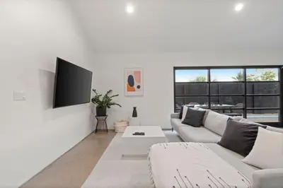 a white living room with a couch and a tv at Modern Home w Heated Pool in Philadelphia