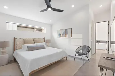 a white bedroom with a bed and a ceiling fan at Modern Home w Heated Pool in Philadelphia