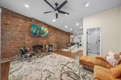 a living room with a brick wall at Free Parking -2BR,2Bath, 4Beds, Sleeps 6, 10 Min to NYC, 10 Min to Path in Hoboken