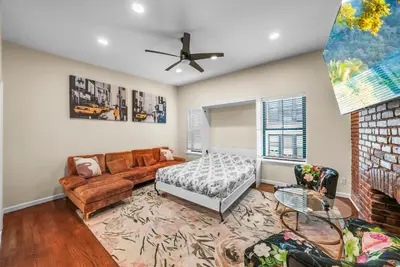 a living room with a couch and a bed at Free Parking -2BR,2Bath, 4Beds, Sleeps 6, 10 Min to NYC, 10 Min to Path in Hoboken