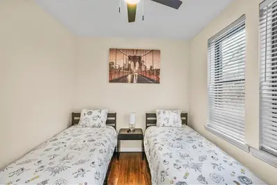 a bedroom with two beds and a window at Free Parking -2BR,2Bath, 4Beds, Sleeps 6, 10 Min to NYC, 10 Min to Path in Hoboken