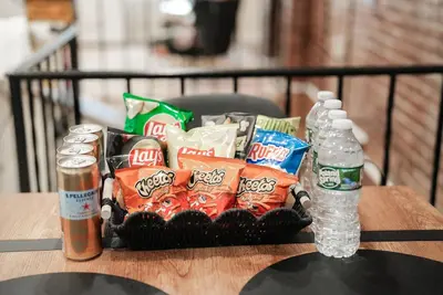 a basket of snacks and a bottle of water on a table at Free Parking -2BR,2Bath, 4Beds, Sleeps 6, 10 Min to NYC, 10 Min to Path in Hoboken