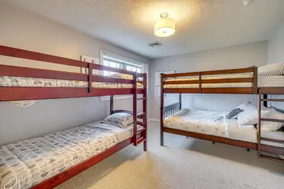 a bedroom with two bunk beds and a window at Spacious Modern Home about 1 Mi to Camelback Mountain! in Tannersville