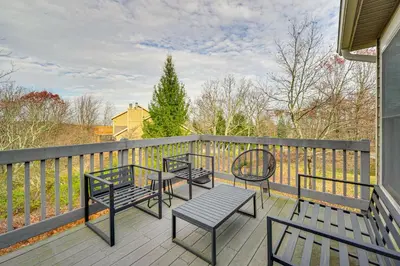 a deck with three chairs and tables on a balcony at Spacious Modern Home about 1 Mi to Camelback Mountain! in Tannersville