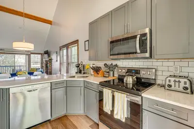 a kitchen with stainless steel appliances and a microwave at Spacious Modern Home about 1 Mi to Camelback Mountain! in Tannersville