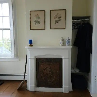 a living room with a fireplace and a window at Peach Grove House in Warwick