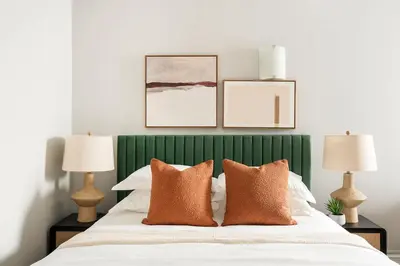 a bedroom with a green and white bed with two lamps at 73-812 New Studio UWS Doorman Gym in New York