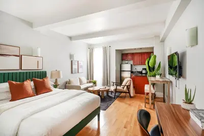 a bedroom with a bed and a living room at 73-812 New Studio UWS Doorman Gym in New York