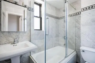 a white bathroom with a sink and a shower at 73-806 New 1BR 1Bth UWS Doorman Gym in New York