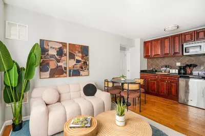 a living room with a couch and a table at 73-806 New 1BR 1Bth UWS Doorman Gym in New York