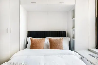 a bedroom with a large white bed with pillows at 73-1509 New Studio UWS Doorman Gym in New York