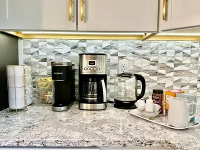 a kitchen counter with a coffee maker on a counter top at The Yuzu stunning mountain retreat with hot tub in Gardiner