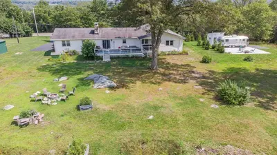 an aerial view of a house with a yard at The Yuzu stunning mountain retreat with hot tub in Gardiner