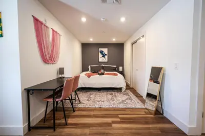 a bedroom with a bed and a desk and a table at Studio Apartment in the Heart of Philadelphia in Philadelphia
