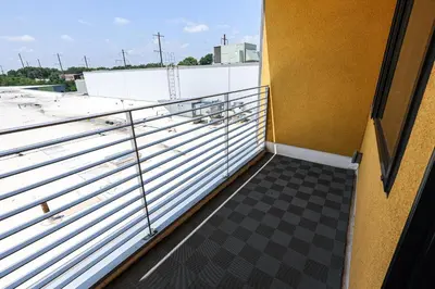a balcony with a metal railing and a checkered floor at Studio Apartment in the Heart of Philadelphia in Philadelphia