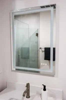 a bathroom with a mirror above a sink at Studio Apartment in the Heart of Philadelphia in Philadelphia