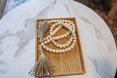 a wooden frame with a bunch of beads on a table at Studio Apartment in the Philadelphia in Philadelphia