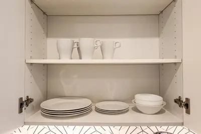 a cupboard with plates and dishes on it at Studio Apartment in the Philadelphia in Philadelphia